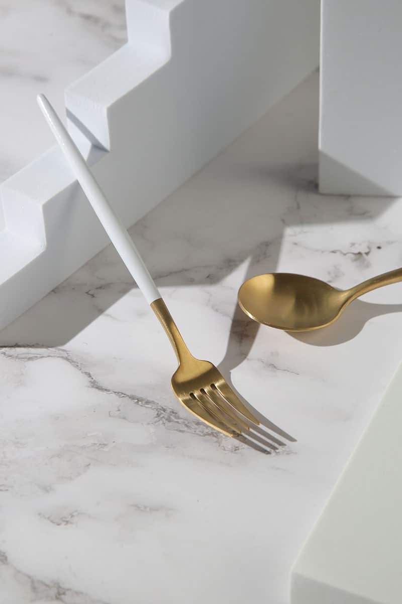 https://www.rossetahome.com/wp-content/uploads/2020/07/matte-gold-stainless-dinner-fork-and-spoon-with-white-handle-2.jpg